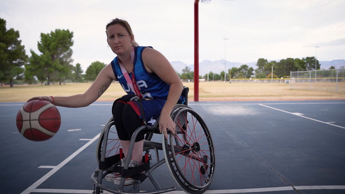 Players in specialized wheelchairs gather on the basketball court, showcasing the dynamic and inclusive sport of wheelchair basketball.