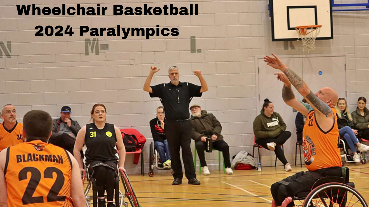 Wheelchair basketball players in action during a 2024 Paralympics game, with a referee and spectators in the background.