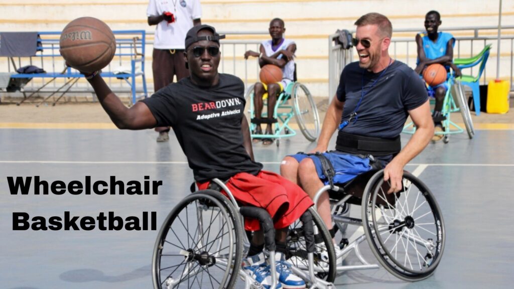 Players in specialized wheelchairs gather on the basketball court, showcasing the dynamic and inclusive sport of wheelchair basketball.